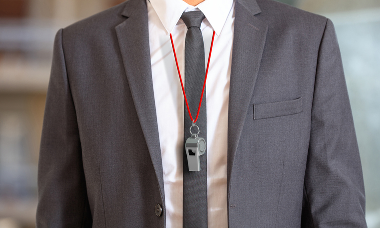 businessman wearing a whistle on a red string