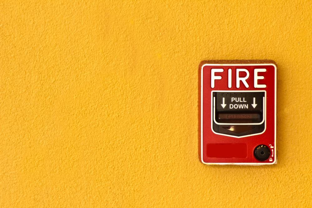 fire alarm on yellow wall