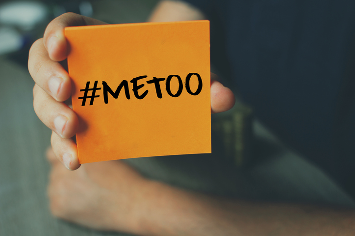 person holding sticky note reading #metoo