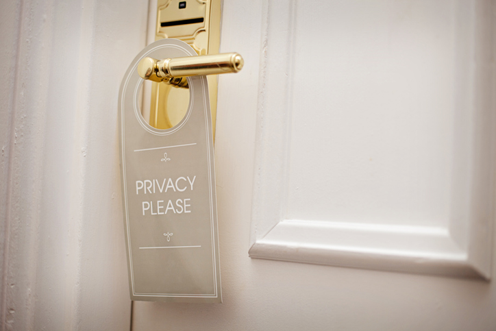 hotel room door with "privacy please" door hanger