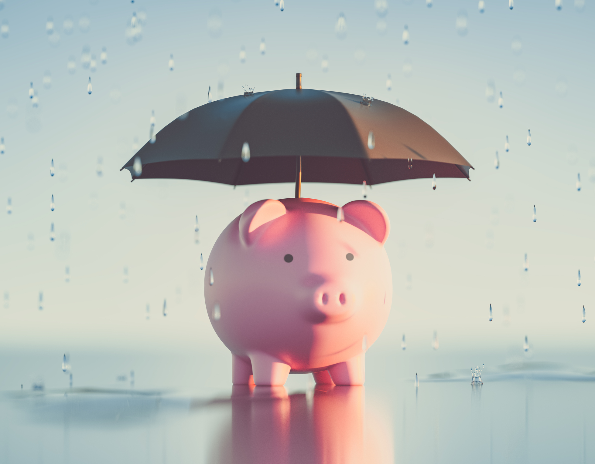 Piggybank underneath an umbrella as it lightly rains