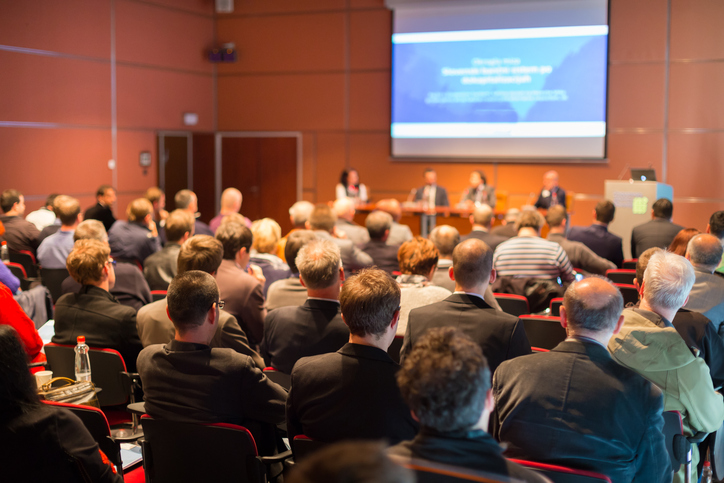 Attendees sit in on conference panel