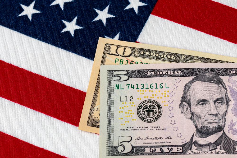 Closeup of ten and five dollar bills with American flag