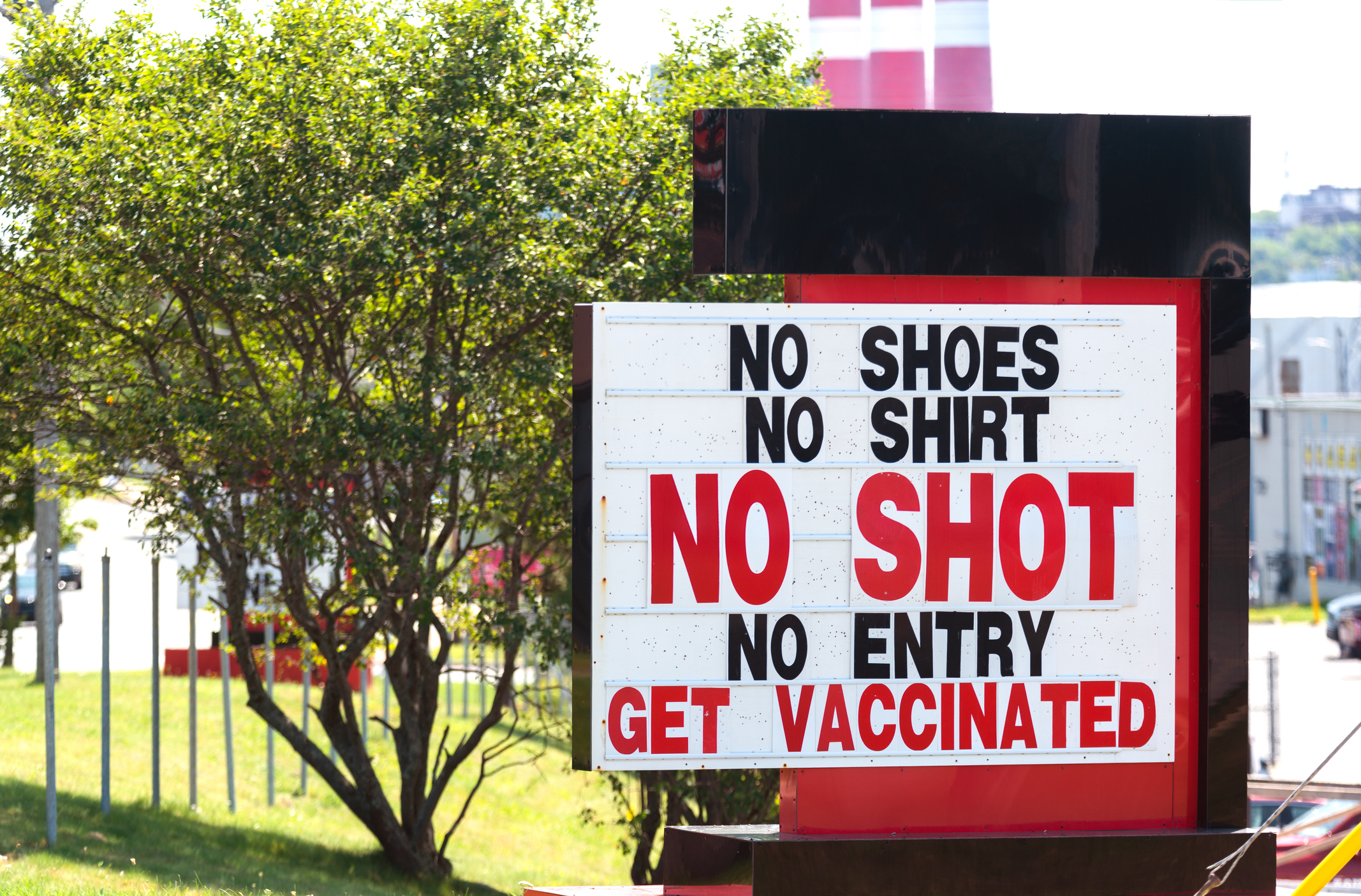 retail sign that reads "no shoes, no shirt, not shot, no entry, get vaccinated"