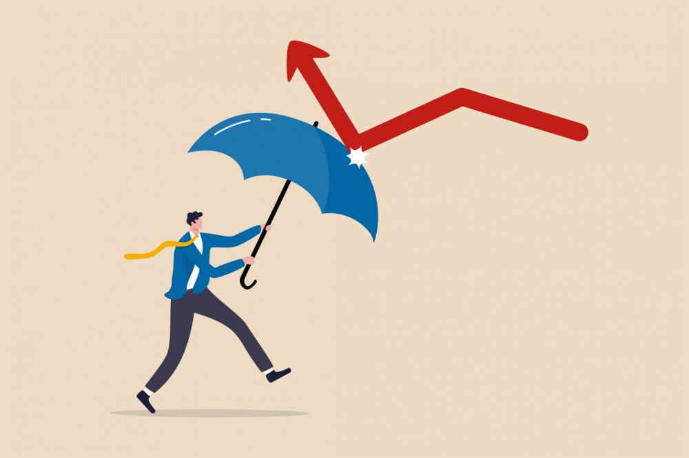 businessman holding strong umbrella to recover red arrow