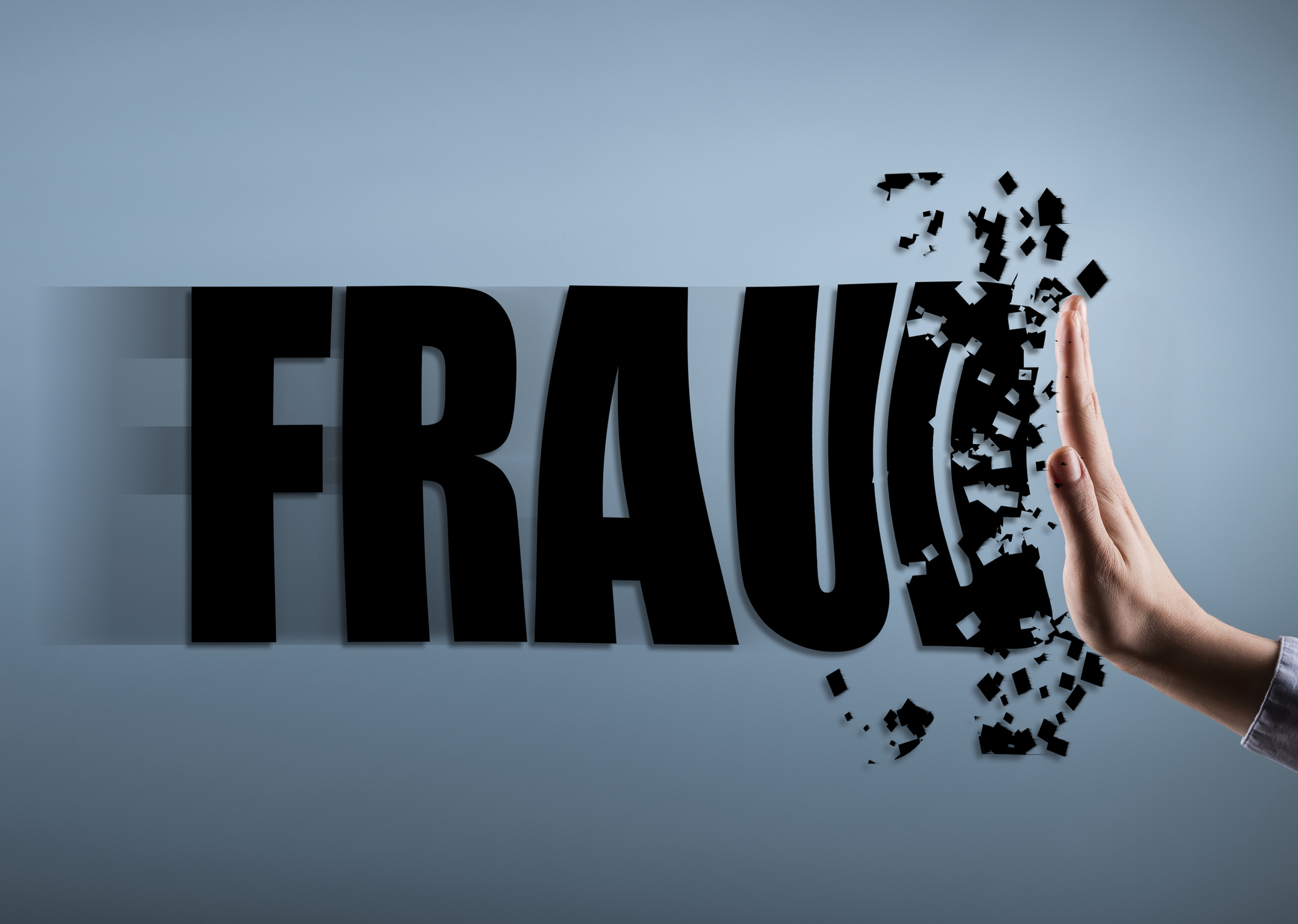 a hand stops and disintegrates the word "fraud" against a blue background
