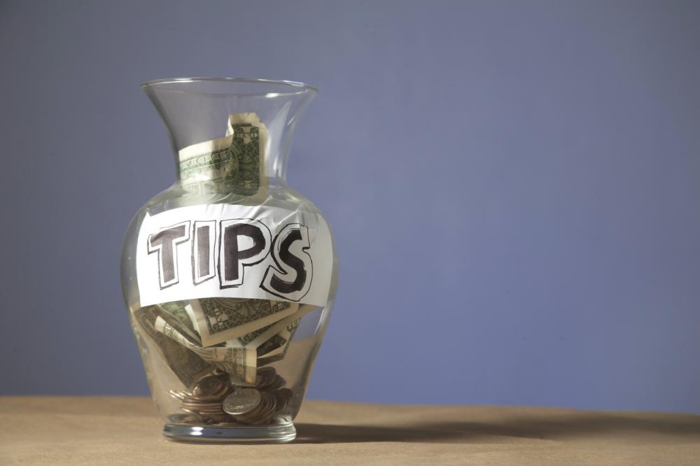 tip jar filled with cash and coins