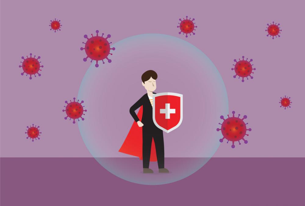 businessman wears a cape and a shield to fight off covid germs