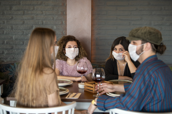 Group of diners wearing face masks at restaurant