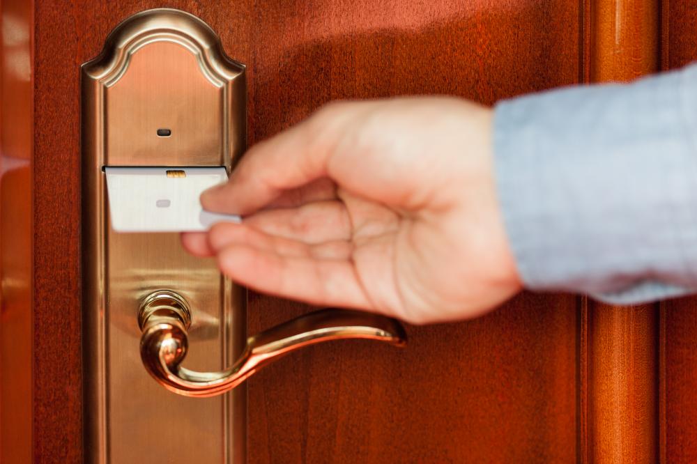 person unlocking hotel room door with card key