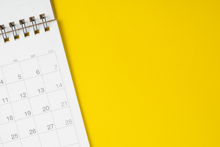 white calendar against solid yellow background