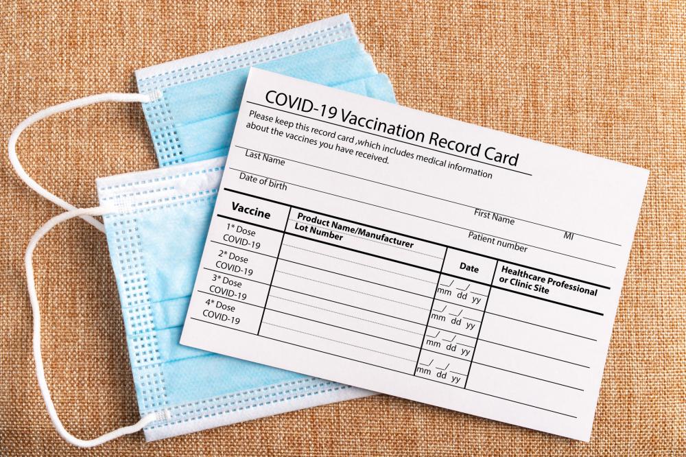 Coronavirus vaccination record card. Protective mask