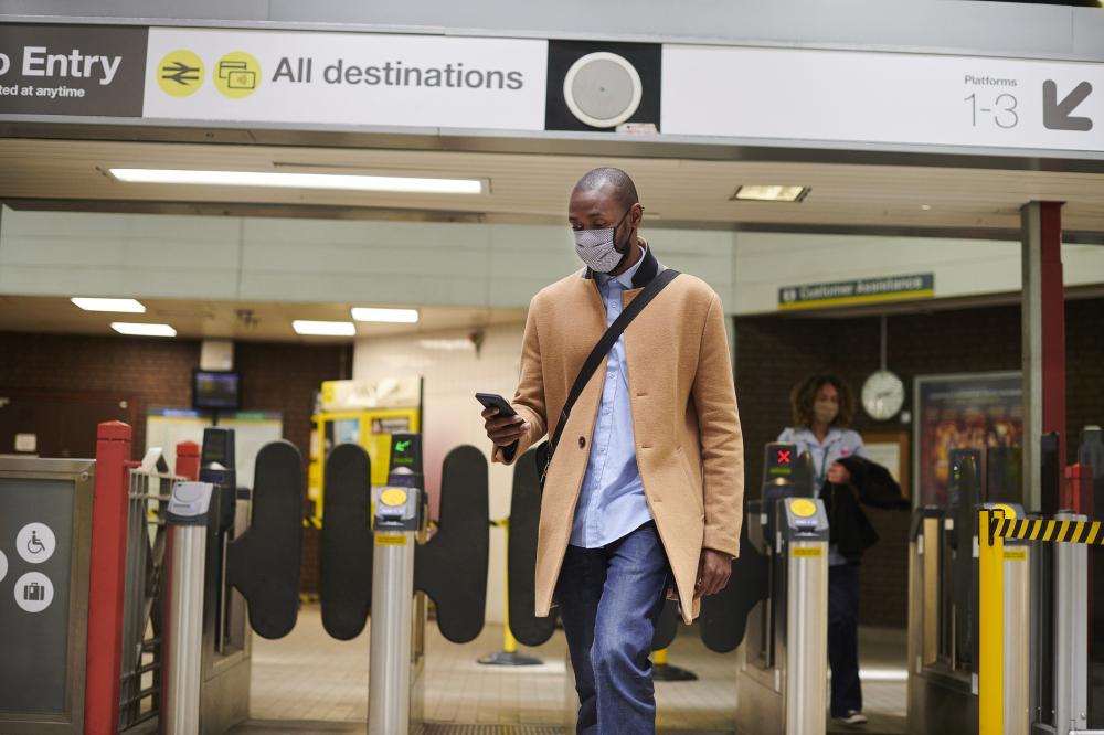 businessman wearing a mask and walking through an airport