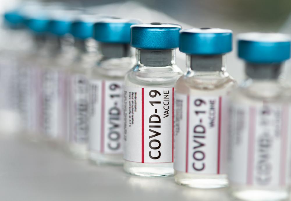 line of vials labelled as covid-19 vaccine