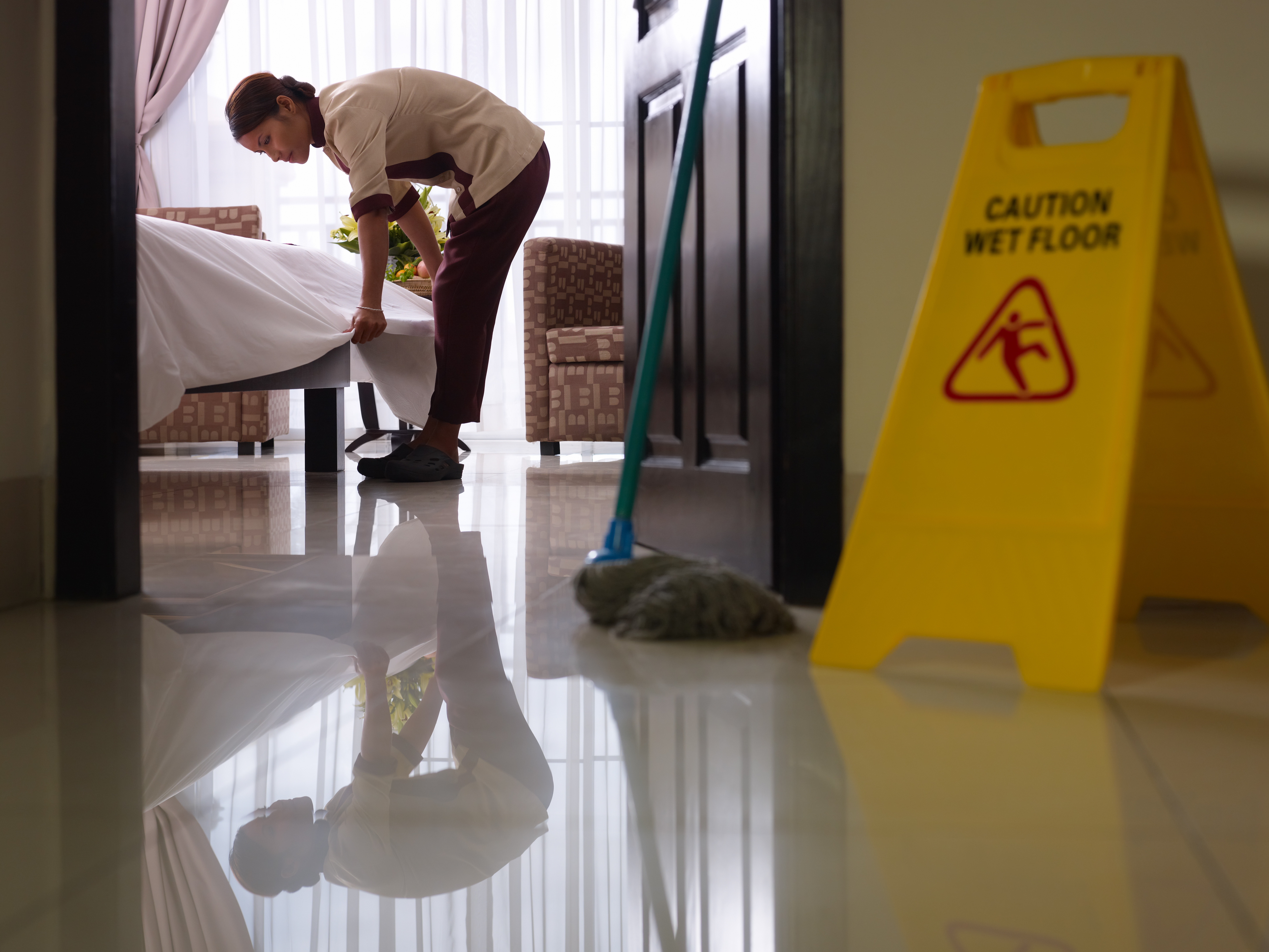 housekeeper cleaning a hotel room