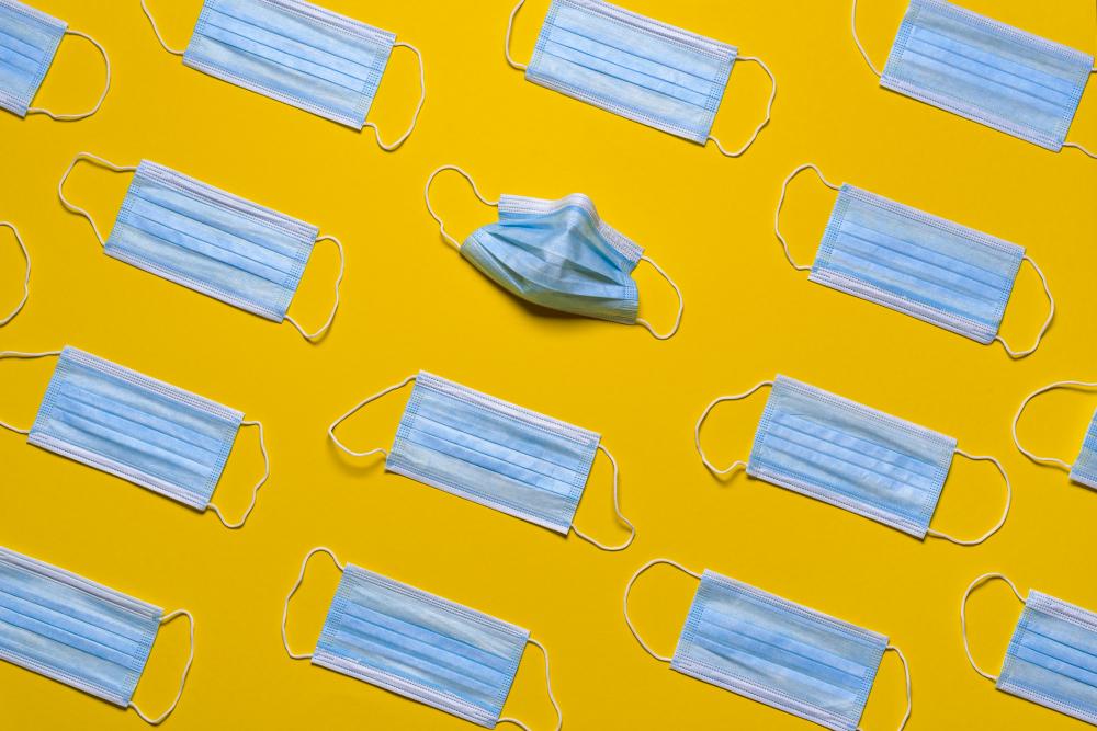 Medical masks isolated on a yellow background