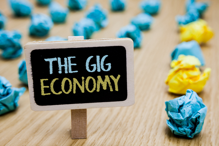 crumpled paper balls next to sign that reads"The Gig Economy"