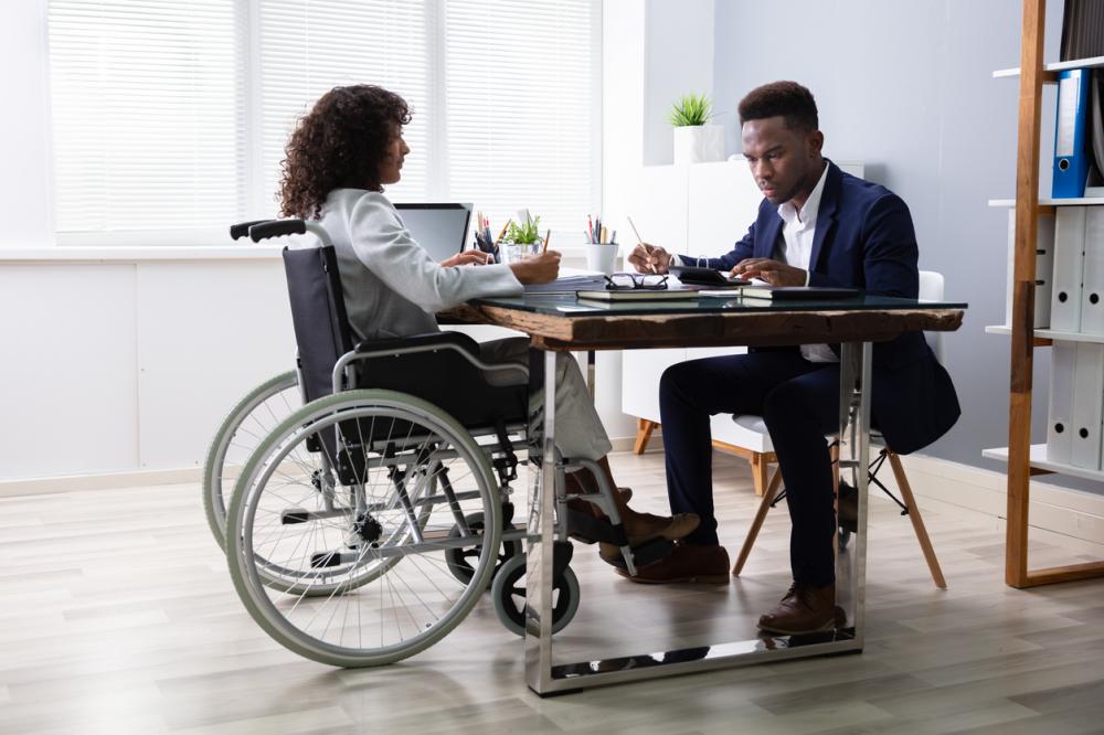 employee in wheelchair talks to hr