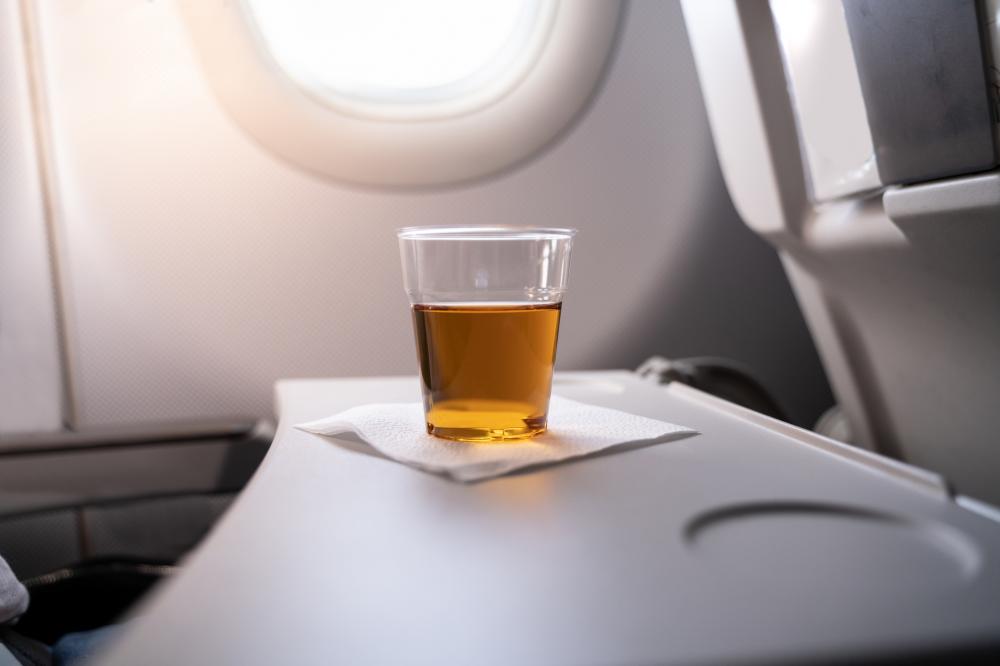 Alcohol Drink On Tray Table In Airplane