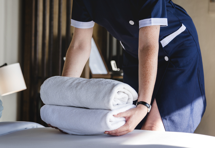hotel housekeepers sets down fresh towels