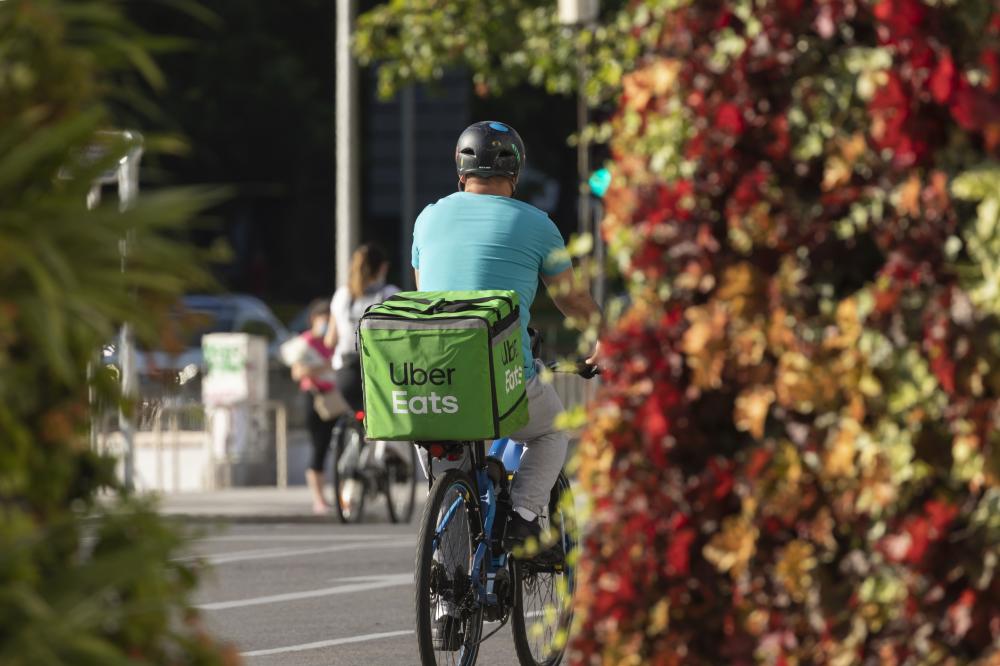 uber eats delivery person riding on a bike