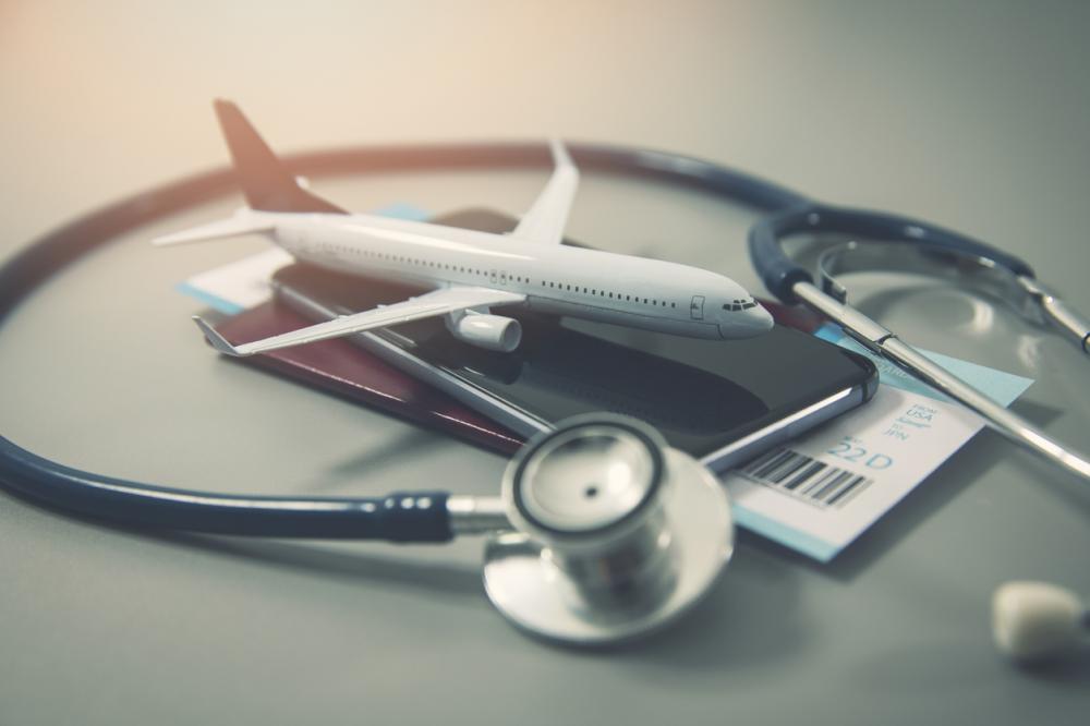 miniature airplane, passport, cell phone, stethoscope